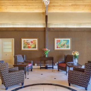 A hotel lobby with comfortable seating and artwork on the walls.
