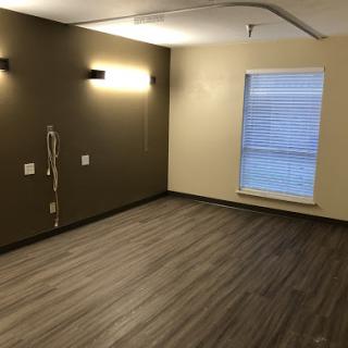 An empty room featuring modern design elements and warm lighting.