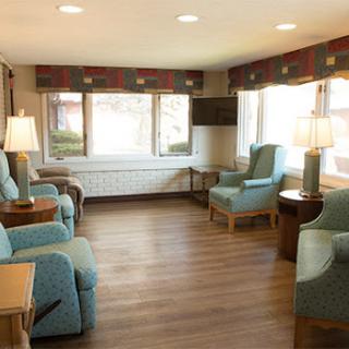 A cozy sitting area with comfortable blue chairs and natural light.