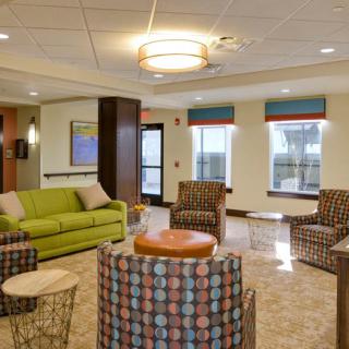 A modern lobby with vibrant seating and elegant lighting.