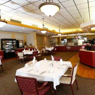 An elegant restaurant dining area with neatly arranged tables and ambient lighting.