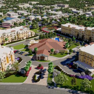Aerial view of a residential complex with multiple buildings and surrounding greenery.