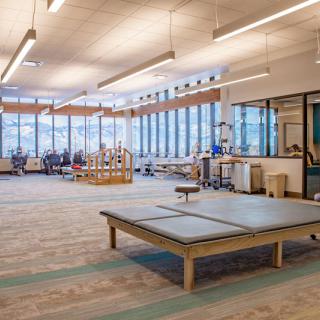 A spacious and modern rehabilitation center equipped with various exercise equipment for physical therapy.