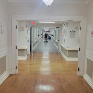 A long, empty corridor in a healthcare facility.