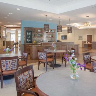 A modern dining area with neatly arranged tables and chairs, complemented by stylish lighting fixtures and decor.
