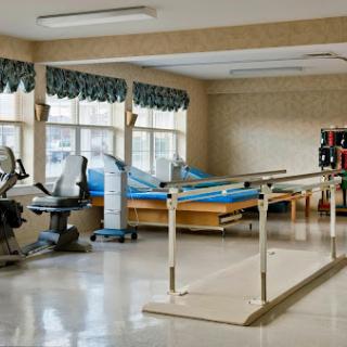 A well-equipped physical therapy room featuring exercise equipment and rehabilitation aids.