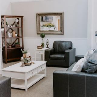 A cozy and modern living room setup featuring stylish furniture and decorative accents.