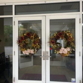 Glass doors adorned with festive wreaths.