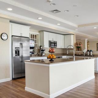 A spacious modern kitchen with a large island and stainless steel appliances.