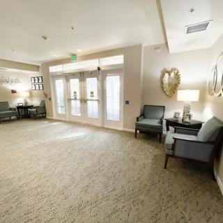 A well-lit lobby area with comfortable seating and elegant decor.