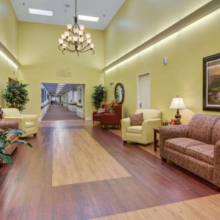 A spacious lobby with comfortable seating, elegant lighting, and decorative elements.