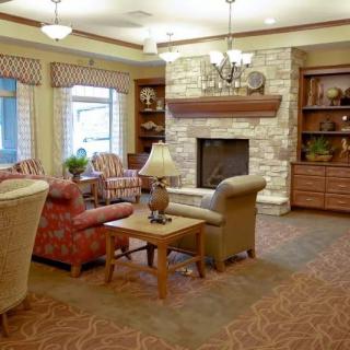A cozy living room featuring a fireplace and comfortable seating arrangement.
