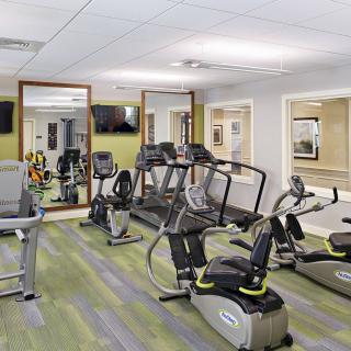 A modern fitness center equipped with treadmills and exercise bikes.