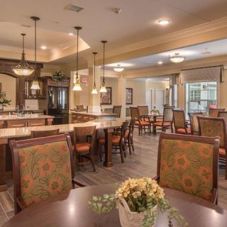 A cozy and well-lit dining area with tables, chairs, and decorative lighting.