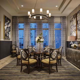 A beautifully decorated dining room with elegant furnishings and wall art.