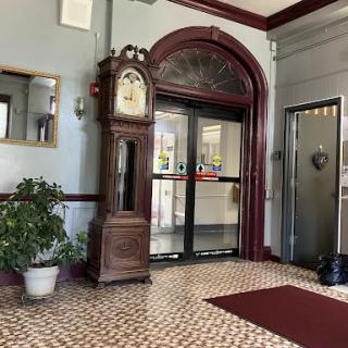 A beautifully decorated lobby featuring a classic grandfather clock and elegant tile flooring.