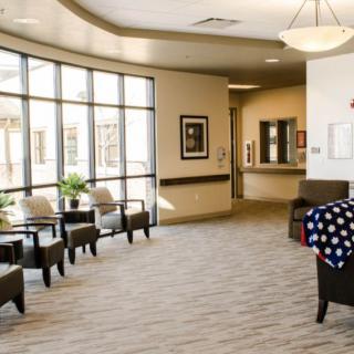 A bright and welcoming lobby area with comfortable seating and large windows.