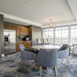 A modern kitchen and dining area with ample natural light and stylish furnishings.