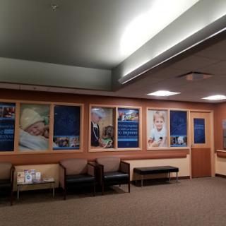 A welcoming waiting area in a hospital, featuring comfortable seating and informative displays.