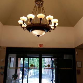 A grand chandelier illuminating the entrance of a building.
