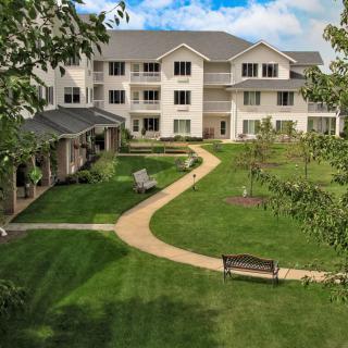 A residential building with a landscaped garden and pathway.