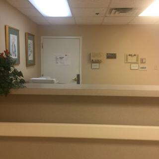A quiet reception area with a desk and wall decorations.