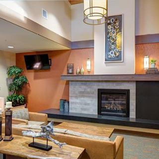 A modern living room featuring a fireplace, stylish wall art, and comfortable seating.