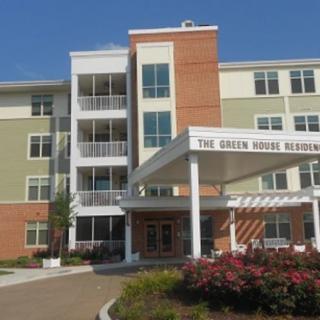 A modern residential building with a welcoming entrance and landscaped surroundings.