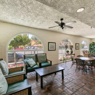A cozy lounge area with comfortable seating and natural light from large windows.