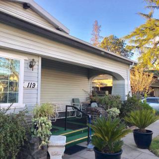 A cozy residential home with a porch adorned with plants.