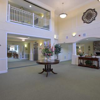 Spacious and elegantly decorated lobby with a central table and surrounding reception area.