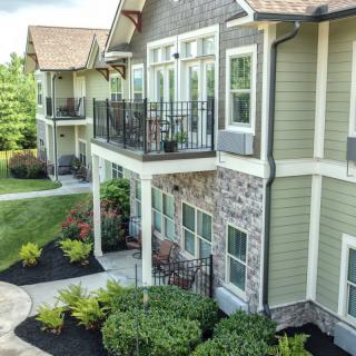 Modern apartment complex with landscaped surroundings and private balconies.