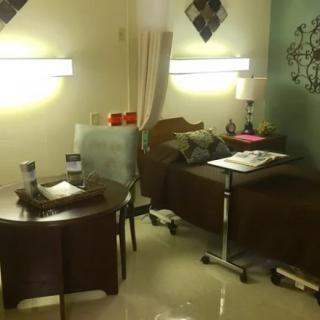 A well-organized hospital room with a bed and medical equipment.
