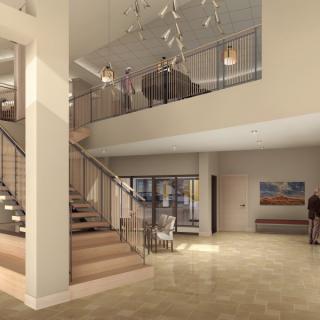 A modern lobby with an elegant staircase and contemporary furnishings.