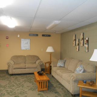 A cozy living room setup featuring comfortable seating and warm lighting.