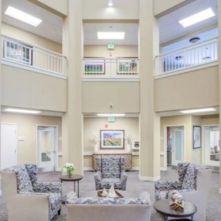 A spacious and well-lit lobby featuring comfortable seating and elegant decor.