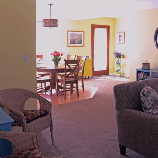 Bright and cozy living area with a dining table and comfortable seating.