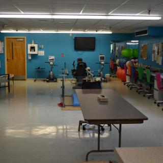 A spacious medical waiting area with colorful chairs and tables, designed to create a welcoming atmosphere.