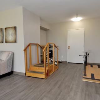 A rehabilitation room equipped with physical therapy exercise equipment.
