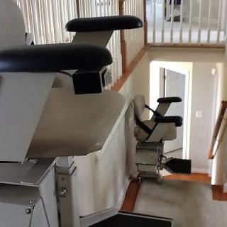 An indoor stair lift provides accessibility on a staircase.