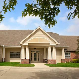 A well-maintained residential building with a neatly landscaped entrance.