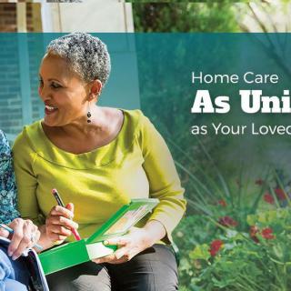 A caregiver provides support and companionship to an elderly person in a serene outdoor setting.