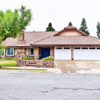 A suburban house with a stone facade and a three-car garage.