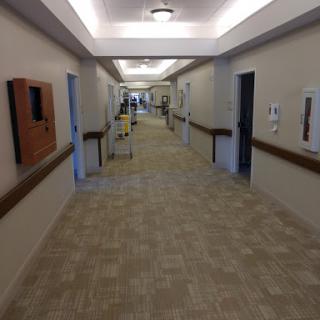 A clean and well-lit corridor in a healthcare facility.