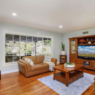 Cozy living room with a sofa, coffee table, and large window.