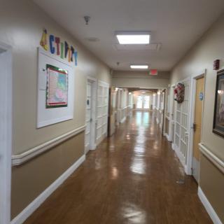 An empty school hallway with bright lighting and artwork on the walls.
