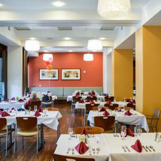 An elegant restaurant dining area with neatly arranged tables and chairs.
