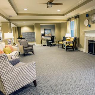 A spacious and elegantly designed living room featuring modern furniture and a cozy fireplace.