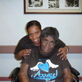A joyful moment shared between a caregiver and an elderly woman.