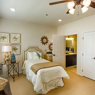 Cozy bedroom with single bed, elegant decor, and ambient lighting.